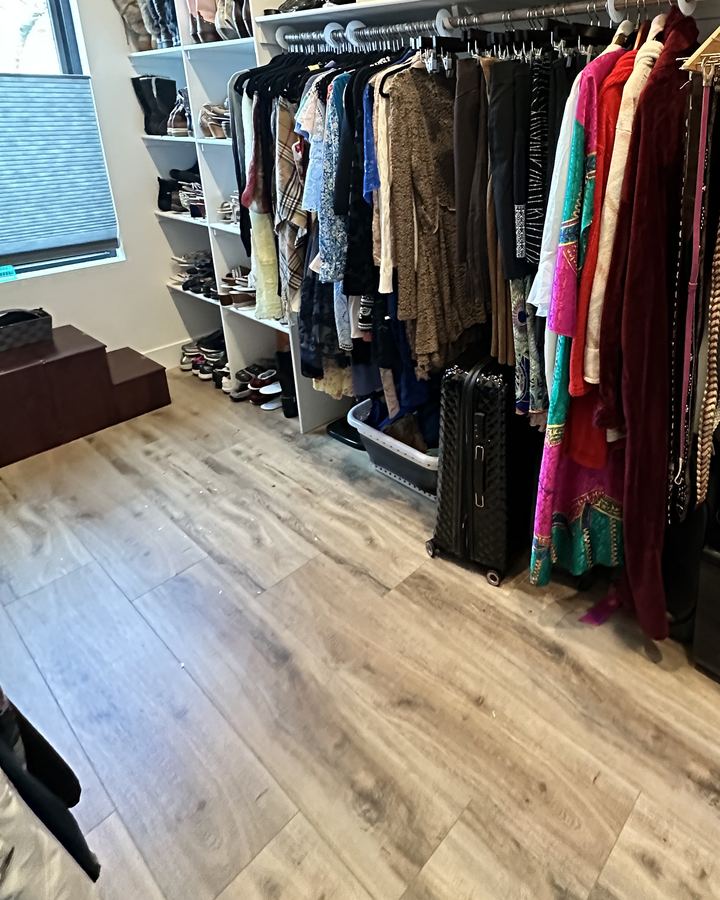 After: the same closet with shoes on shelves, clothes hung and an open floor