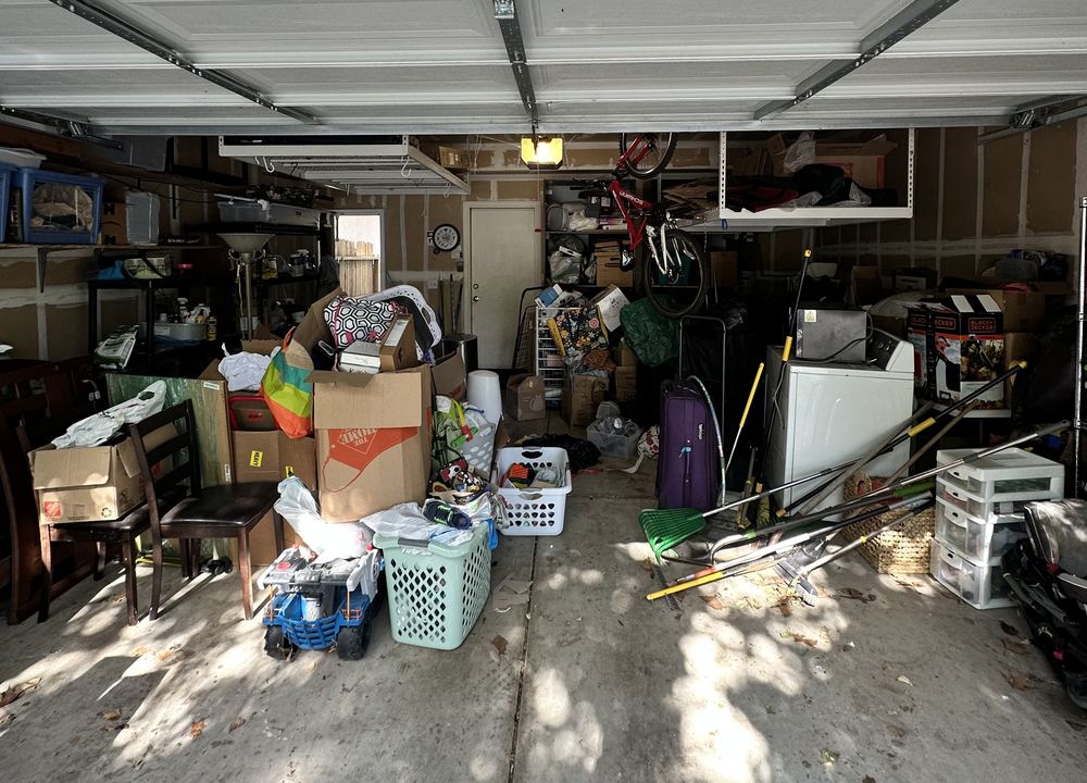 Before: a garage packed with boxes, baskets, toys and tools