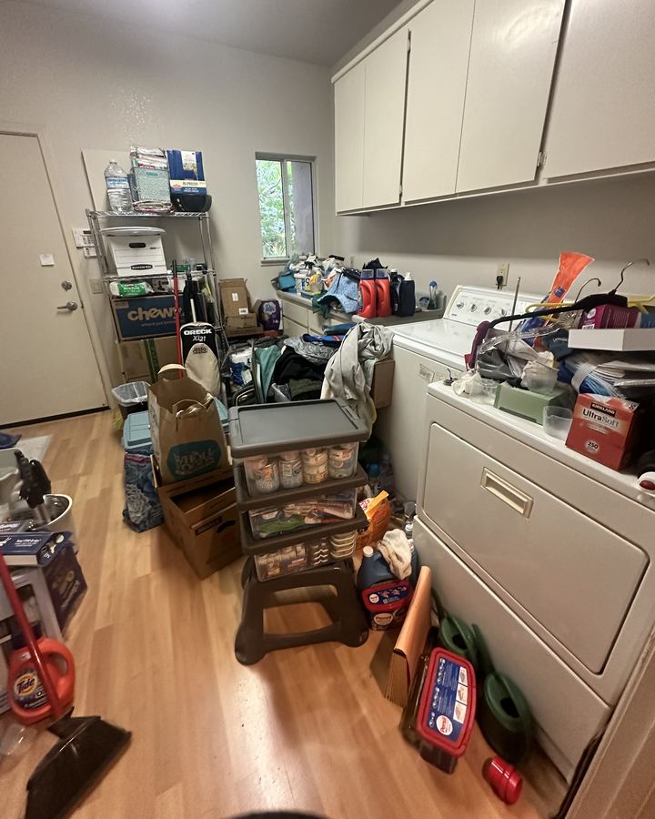 Before: a laundry room crowded with boxes, bins and supplies