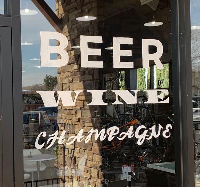 Hand-painted window lettering reading Beer, Wine, Champagne